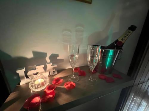 a table with two glasses and a bottle of wine at Suite - Villa La Terrazza Sul Mare in Trabia