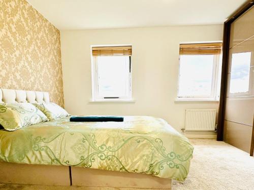 a bedroom with a bed and two windows at Best Places to Stay in Kent in Kent