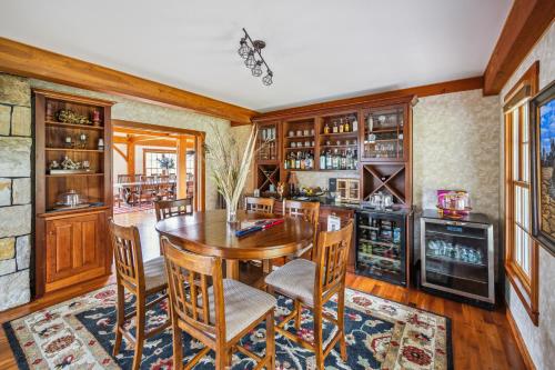 a dining room with a wooden table and chairs at Tigertown Lodge home in White River Junction