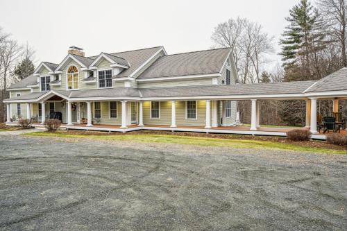 a large house with a driveway in front of it at Tigertown Lodge home in White River Junction