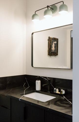 a bathroom with a sink and a mirror at Unit A, The Kroger Lofts in Charlevoix