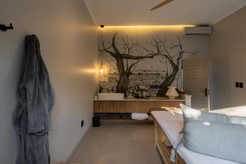 a living room with a tree mural on the wall at Thornybush Simbambili Lodge in Sabi Sand Game Reserve