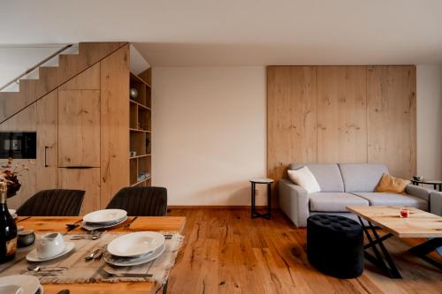 a living room with a table and a couch at Apartmán 2Brezy Tatry in Stará Lesná