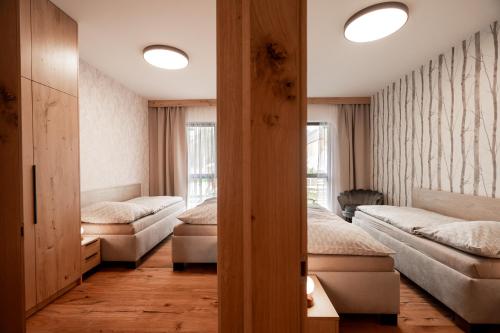 a room with two beds and two windows at Apartmán 2Brezy Tatry in Stará Lesná