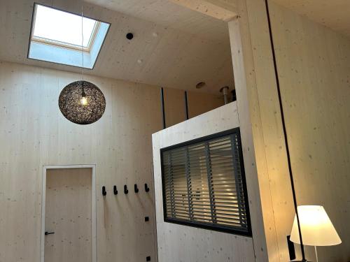 a room with a window and a pendant light at Bio Design Appartements DAS GRAUE SCHAF - Kärnten Card im Sommer inklusive in Bad Kleinkirchheim