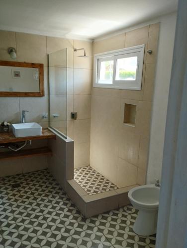 a bathroom with a shower and a sink and a toilet at Starry Lodge in Ciudad Lujan de Cuyo