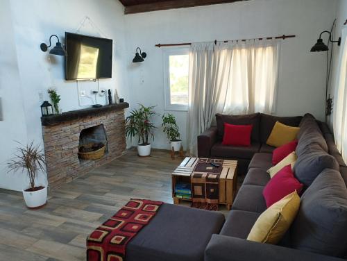 a living room with a couch and a fireplace at Starry Lodge in Ciudad Lujan de Cuyo