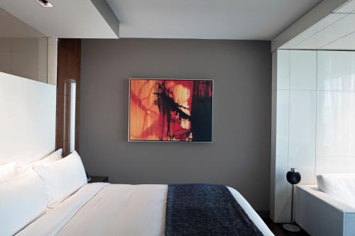 a bedroom with a bed and a painting on the wall at Hotel Beaux Arts, Autograph Collection in Miami