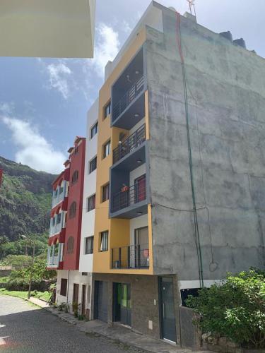 a building with balconies on the side of it at Apartamentos Modernos Santo Antão in Ribeira Grande