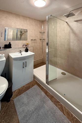 a bathroom with a shower and a sink and a toilet at Brand New Scotland home 3rooms near Glasgow in Clydebank