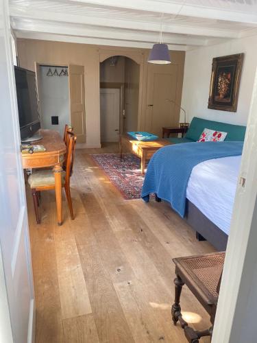 a bedroom with a bed and a desk with a computer at Beautiful renovated Farmhouse in Ankeveen