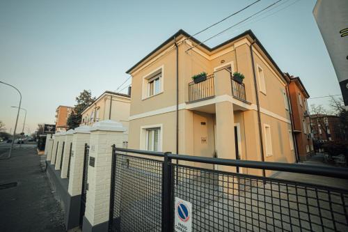 a building with a fence in front of it at Fellini Rooms in Ferrara