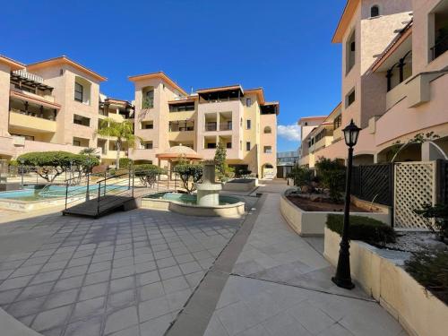 a courtyard in a apartment building with a street light at Queens gardens in Paphos