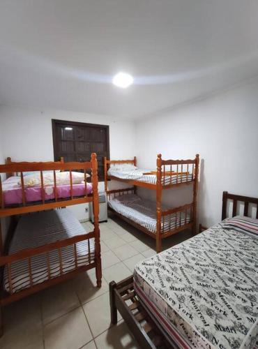 a room with three bunk beds in a room at Chácara Mamma Mia in Lindóia
