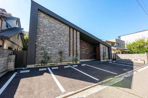 a parking lot in front of a brick building at SAUNA VILLA 然 in Nagano