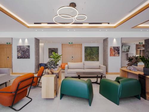 a waiting room with colorful chairs and tables at Radisson Hotel & Spa Gyumri in Gyumri