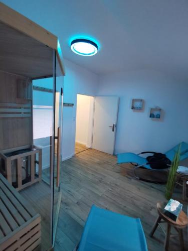 a living room with a blue light on the ceiling at Bergstadt Apartment Lautenthal ,Modern, Stylisch, Geräumig in Lautenthal