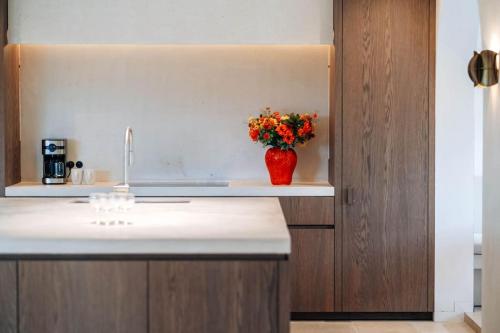 a kitchen with a vase of flowers on a counter at Heuvelrust Lumina - 14pers in Westouter