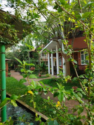 a house with a garden in front of it at Inn Pondiville Forest Retreat in Puducherry