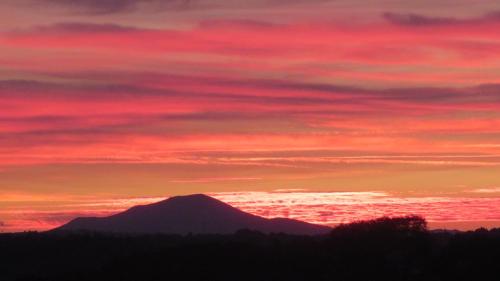 a mountain under a red sky at sunset at Marie-Pierre in Ciboure