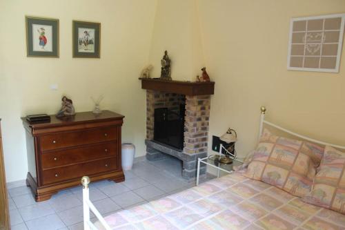 a bedroom with a bed and a fireplace at Maison individuelle in Ossun