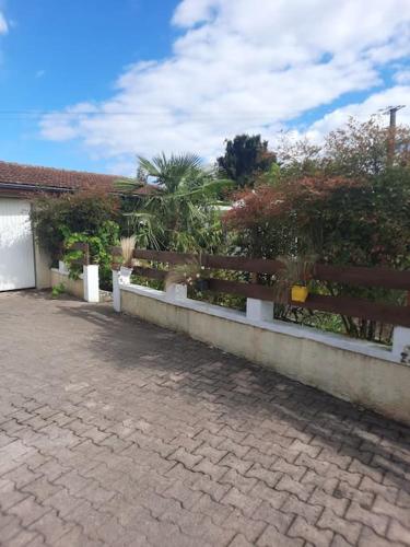a fence in front of a house with plants at Maison individuelle in Ossun