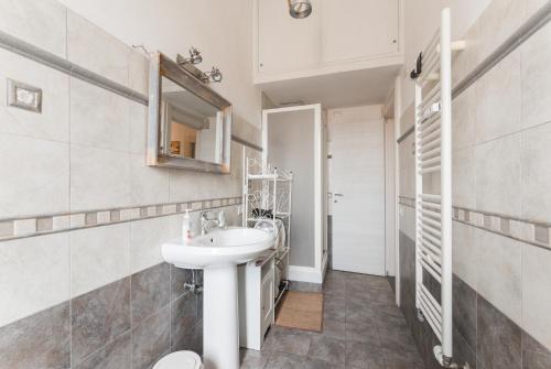 a bathroom with a sink and a mirror at Casa Via Cesena in Rome