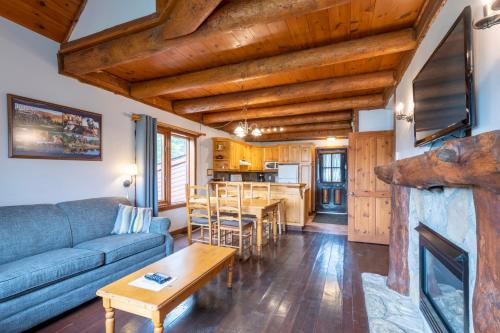 a living room with a couch and a table at Royal Laurentien in Mont-Blanc