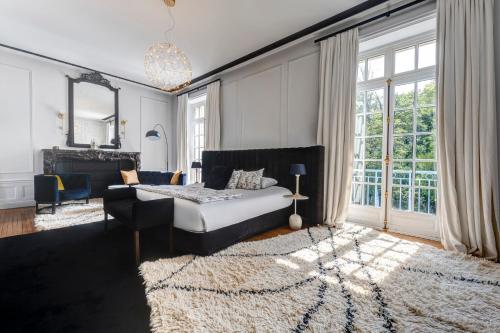 a bedroom with a bed and a large window at Château des Avenieres in Cruseilles