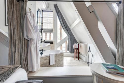 a bathroom with a large window and a sink at Château des Avenieres in Cruseilles
