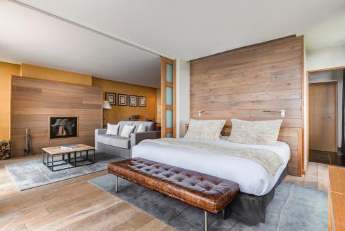 a bedroom with a large bed and a couch at Château des Avenieres in Cruseilles