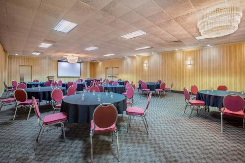 a conference room with blue tables and pink chairs at Days Inn by Wyndham Sudbury & Conference Centre in Sudbury