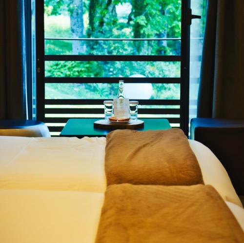 a bedroom with a bed and a table and a window at Château des Avenieres in Cruseilles