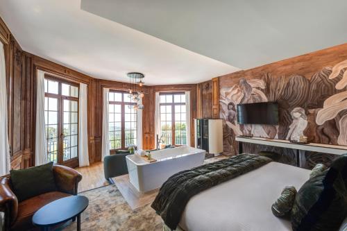 a bedroom with a large bed and a sink at Château des Avenieres in Cruseilles