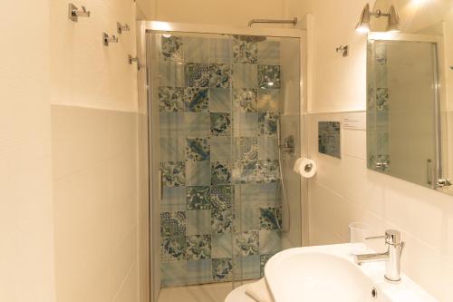 a bathroom with a shower and a toilet and a sink at La casa del Geologo in Stromboli