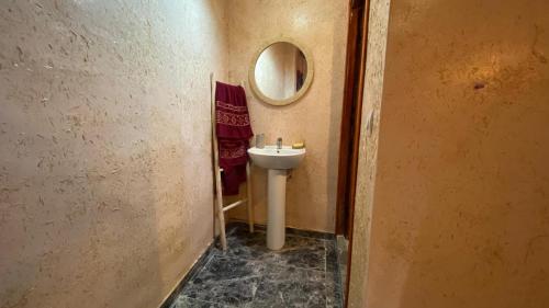a bathroom with a sink and a mirror at Tangomar club kech in Marrakech
