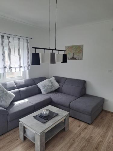 a living room with a couch and a coffee table at Villa-Galliet in Buzsák
