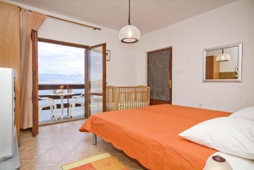 a bedroom with a bed and a view of the ocean at Apartments Ljilja in Nin