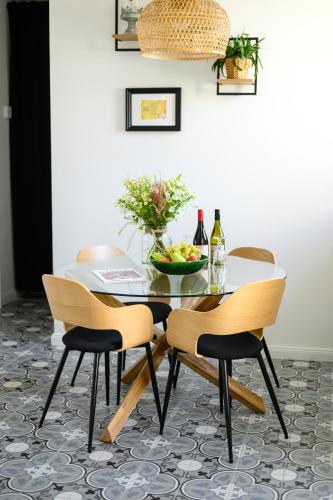 a dining room table with chairs and a bowl of fruit at Zengő in Eger