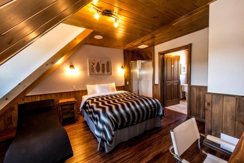 a bedroom with a bed and a staircase at Royal Laurentien in Mont-Blanc