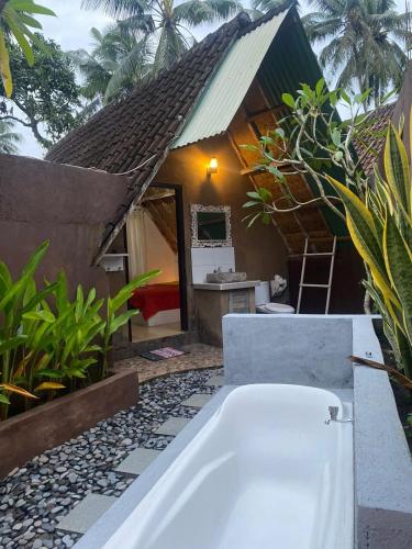 a bath tub in front of a house at Alam Kowang Villa in Tejakula