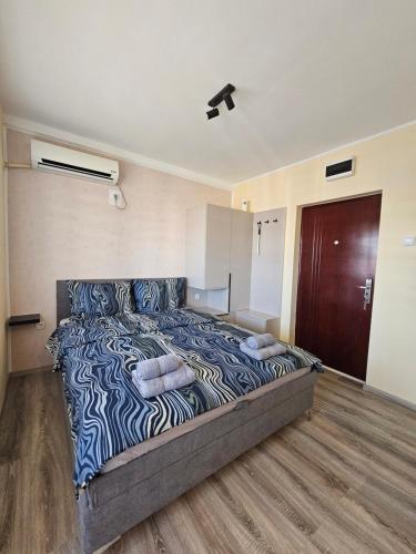 a bedroom with a large bed with two pillows on it at Apartman Slađa in Novi Sad