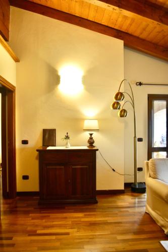 a living room with a lamp on a wall at Agriturismo Colle Mura in Morano Madonnuccia