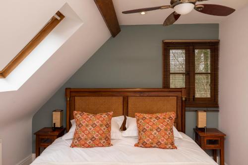 a bedroom with a bed with two pillows at The Hideaway-South Downs National Park in Graffham