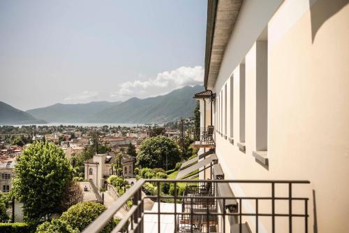 a balcony with a view of a city at Hotel Belvedere Locarno in Locarno