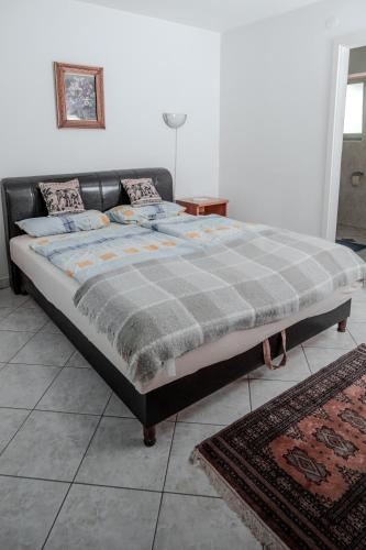 a large bed sitting in a room with at Edi Birtok in Oroszló