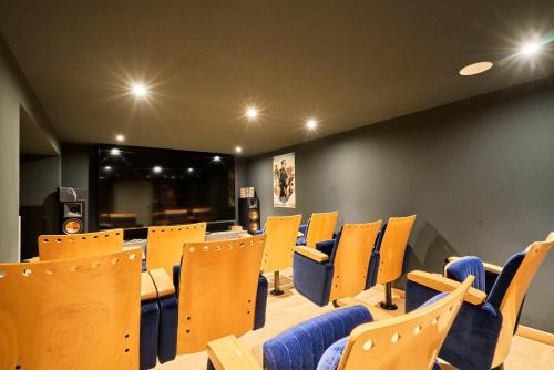 une salle de conférence avec des chaises jaunes et une table dans l'établissement VILLA ARCADIA - Piscine - Spa - Sauna - Cinéma - Jeux d'arcades - Jeux vidéo - Bassin naturel - Jardin, à Seclin