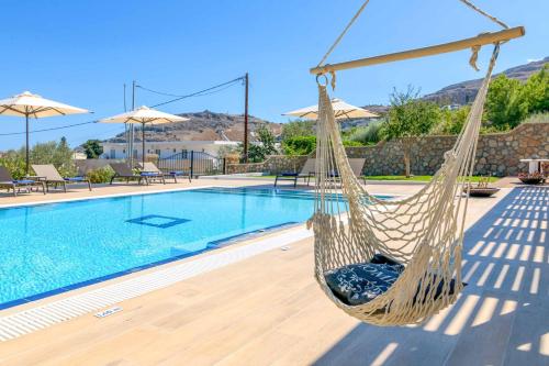 a hammock next to a swimming pool at Villa Krini Eleni in vlicha