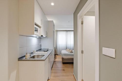 a kitchen with a sink and a counter top at Lovely studio fully equipped near subway N1 in Lisbon