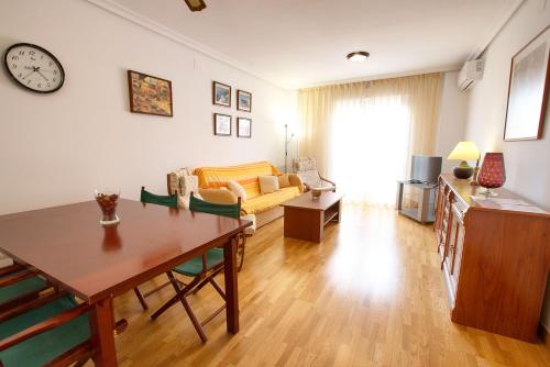 a living room with a table and a couch at Cuencaloft San Vera in Cuenca